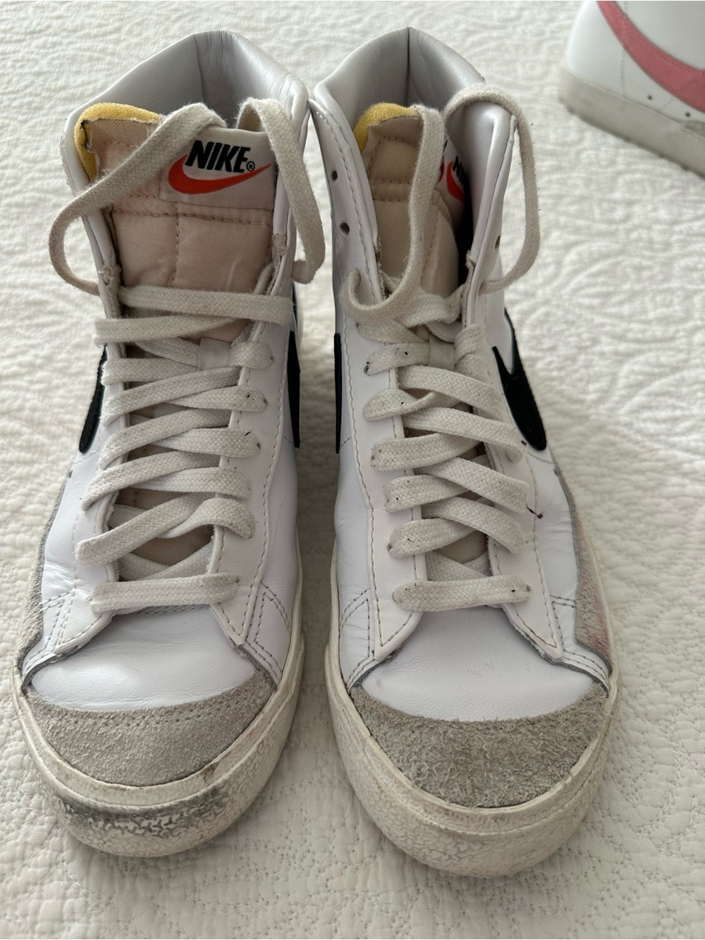 Nike White High-Top Sneakers with Black Swoosh and Orange Tongue Accent
